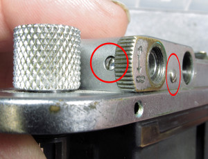 remove the rear screw (oblong circle) and the Diopter adjust post (circle)